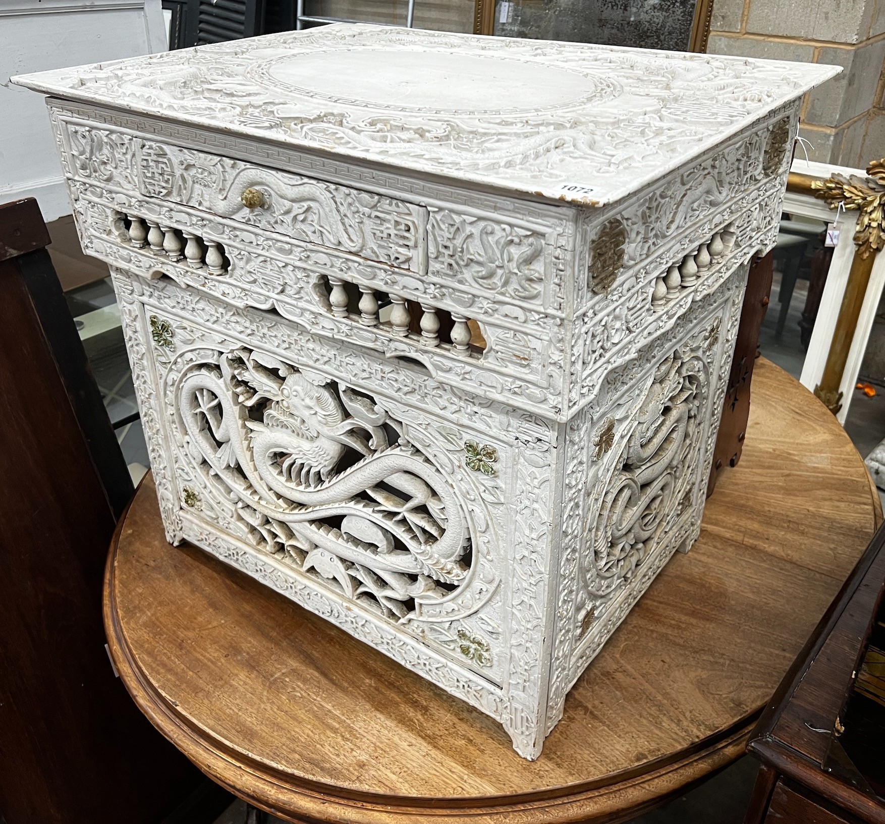 An early 20th century Chinese carved side table, width 75cm depth 56cm height 67cm (later painted)